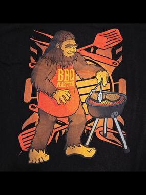 BBQ Master Sasquatch Graphic Tee - Black with Orange & Yellow Print
